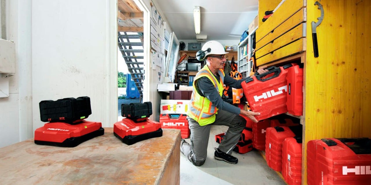 image of person putting a red tool case on to some shelving