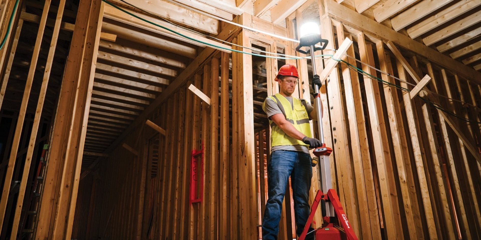 man standing next to hilti lamp